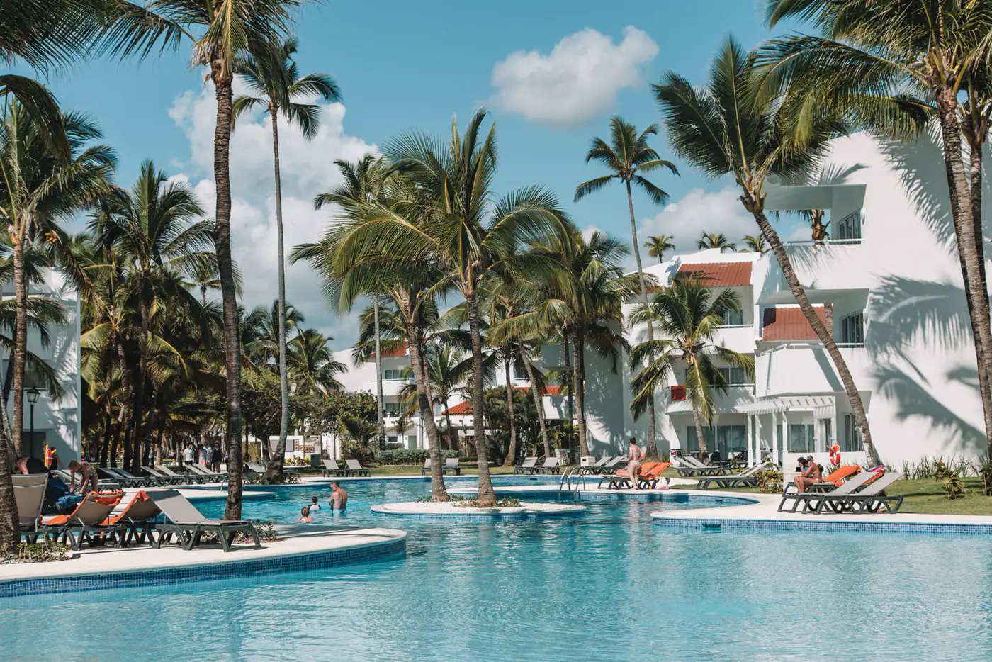 Resort pool lined with palms in Punta Cana